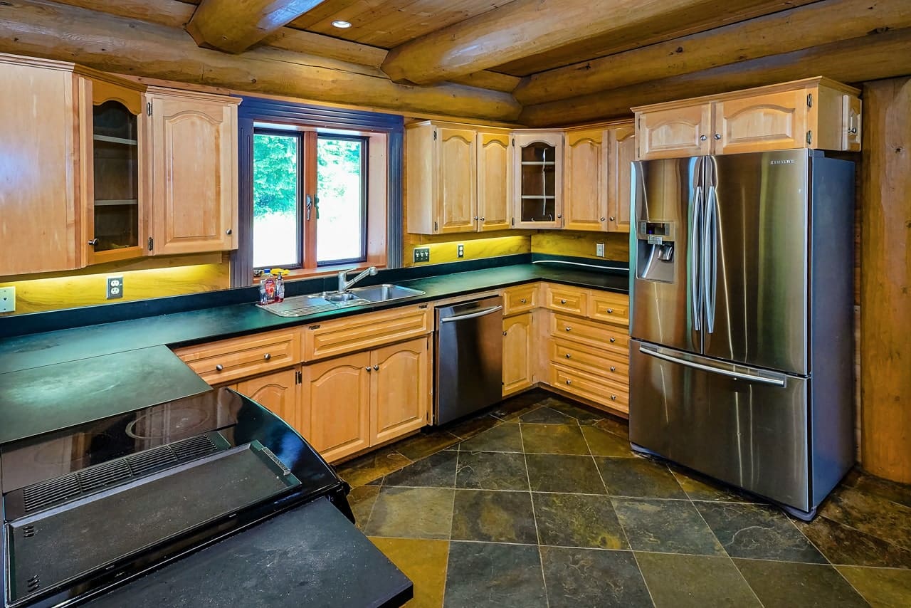 Kitchen of BC Home Builders Custom Full Scribe Log Home.