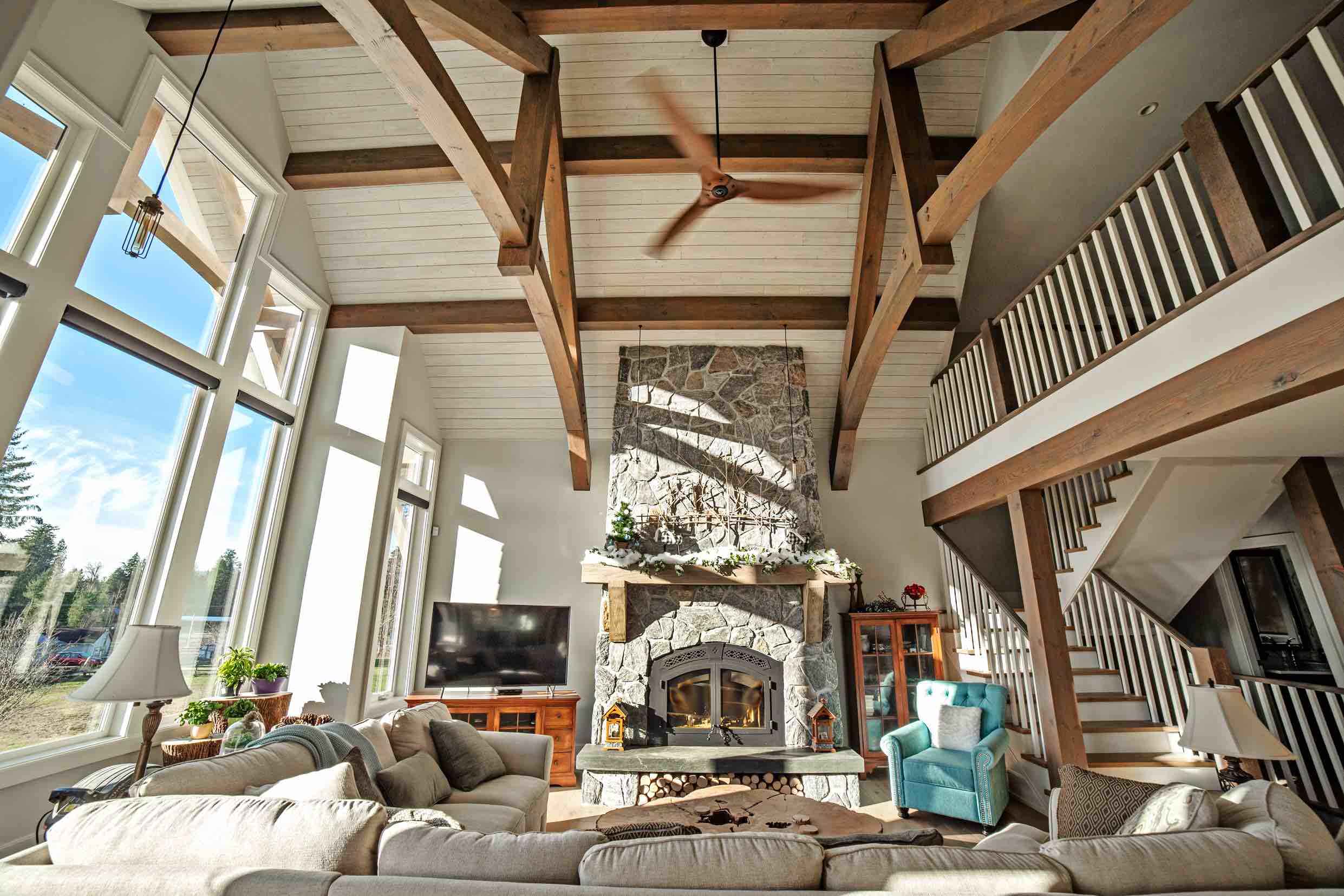 Living area with fireplace in custom built Timber Frame Log Home.