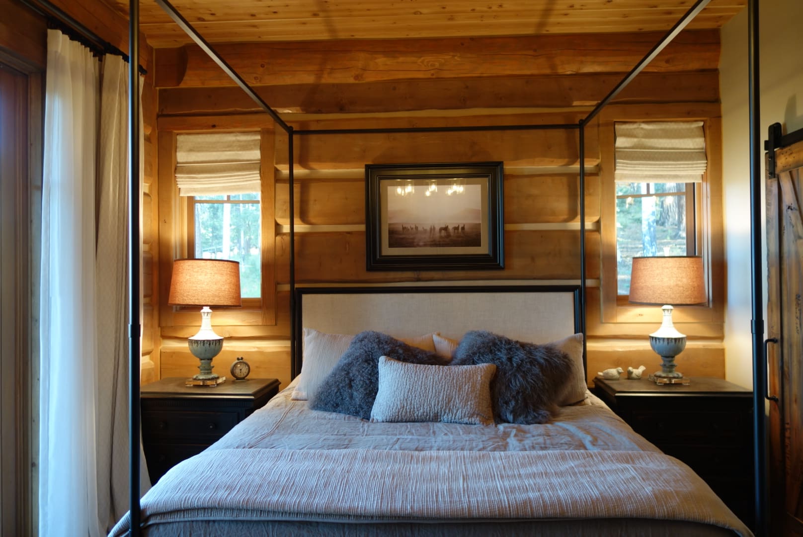 Bedroom in Post and Beam Log home by BC Log Home Builders.