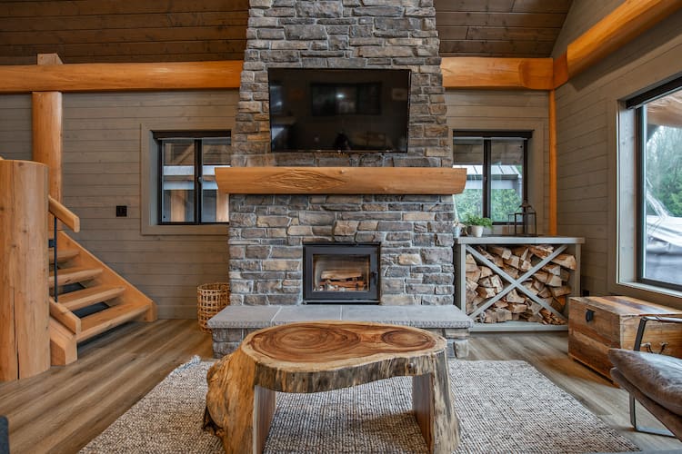 living area with fireplace in log cabin kit