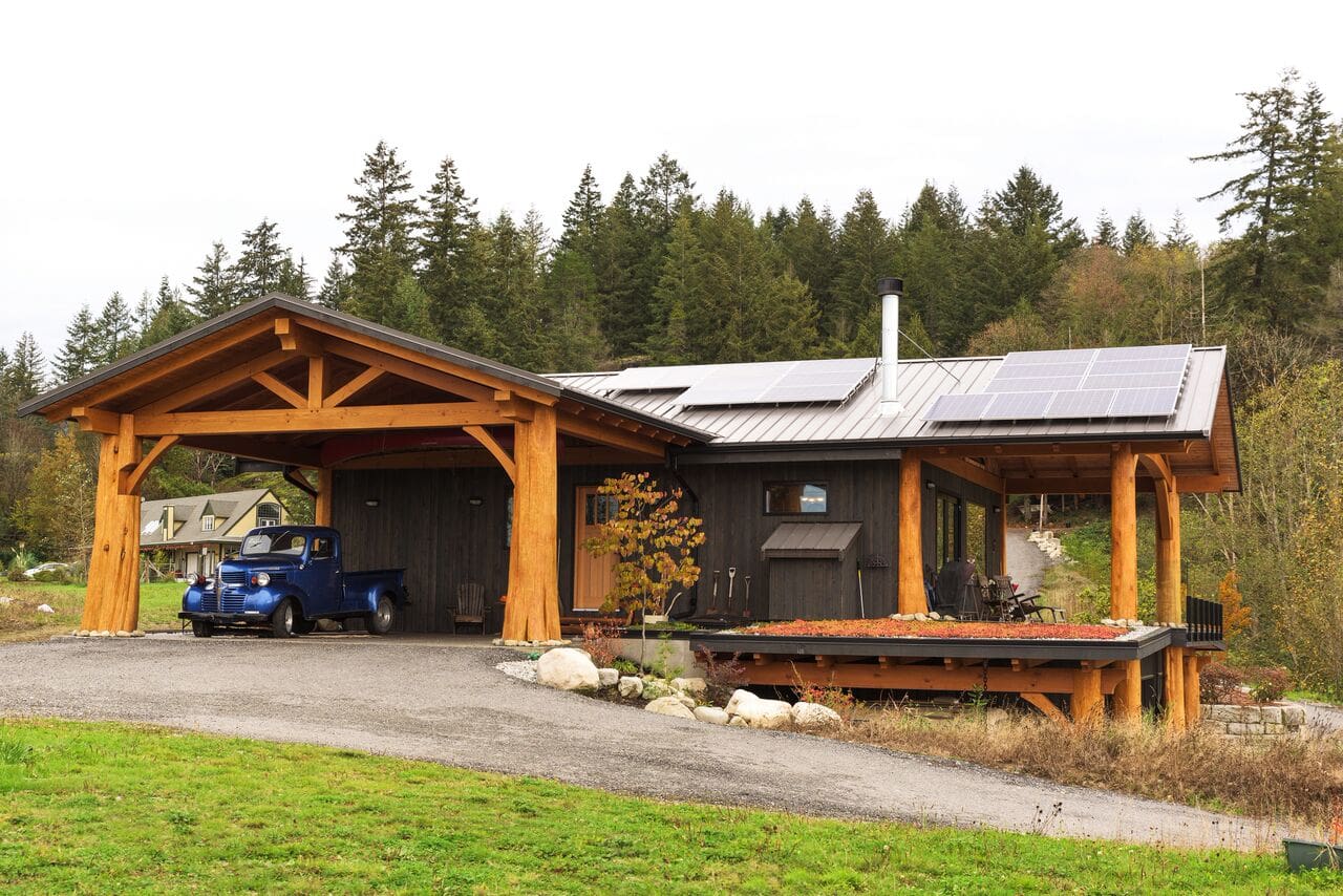 Exterior and Car port of Timber Frame Log home by BC Log Home Builders.