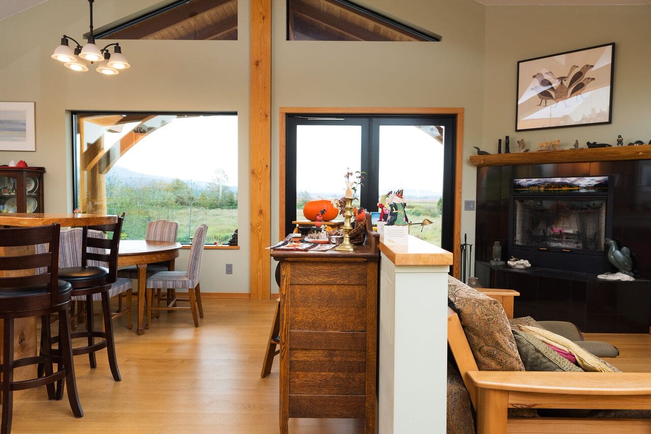 Kitchen and Living Area of Timber Frame Log home by BC Log Home Builders.