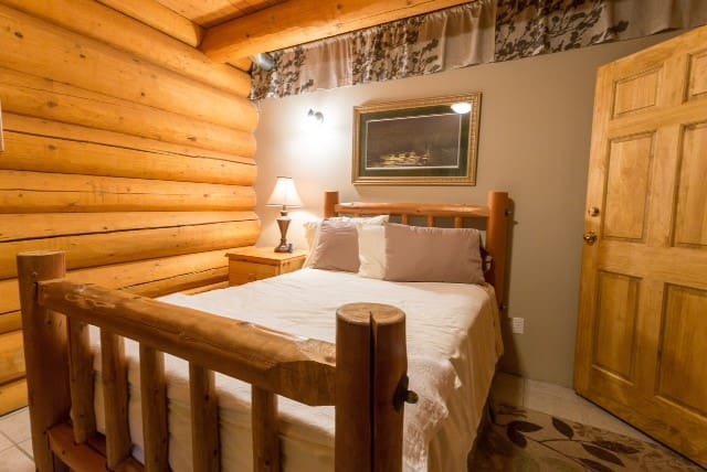 bedroom of BC Log Home Builders Log Home.